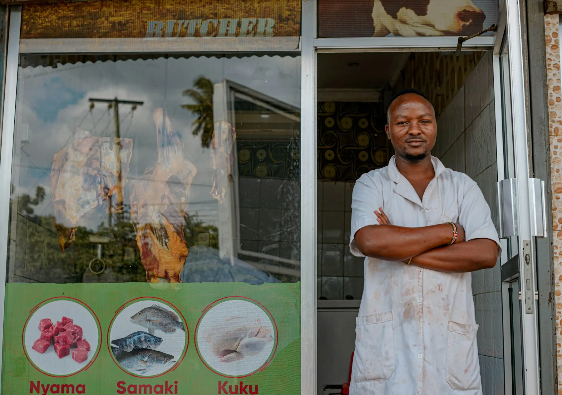 A shopkeeper standing at his shop door