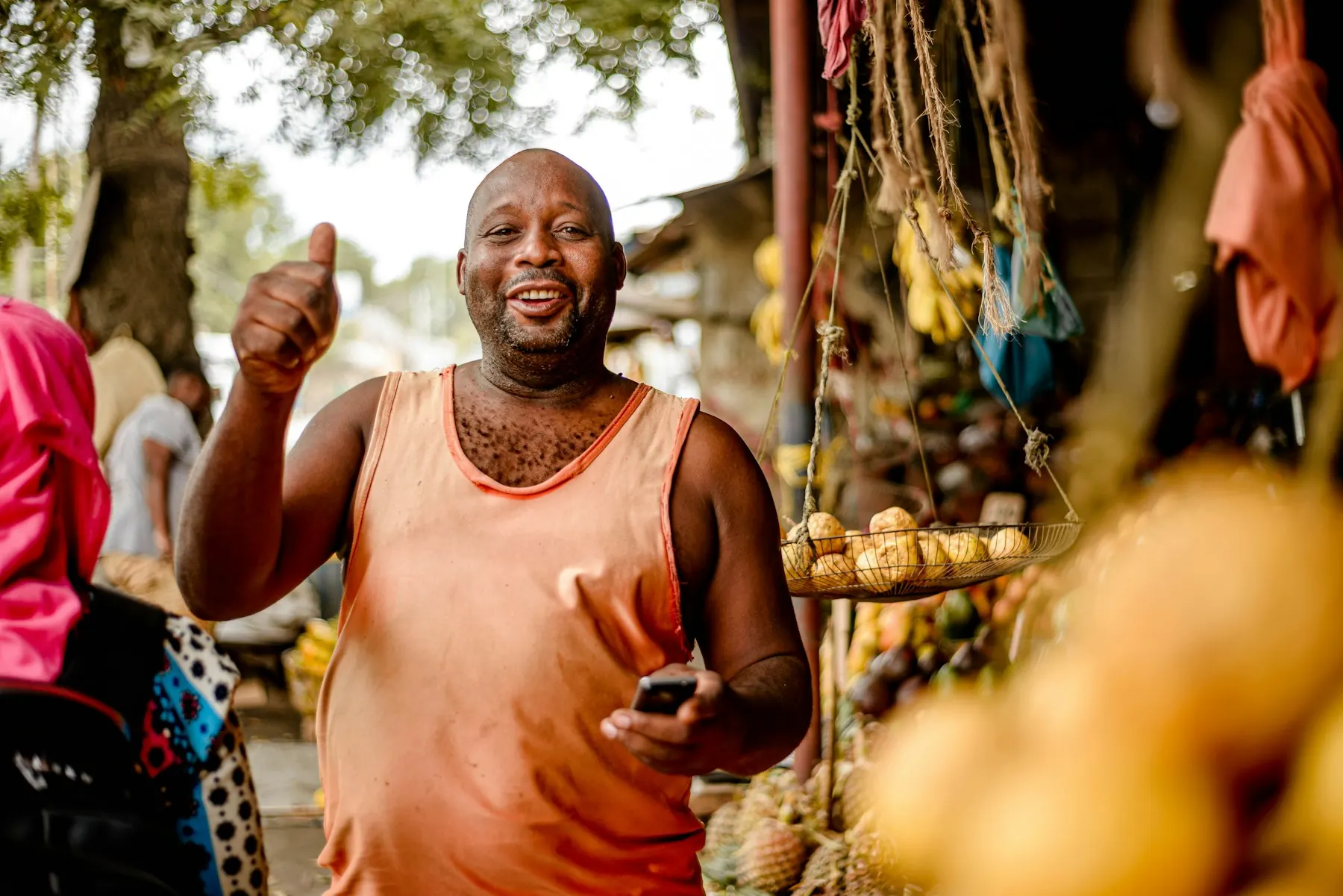 A market trader giving a thumbs up