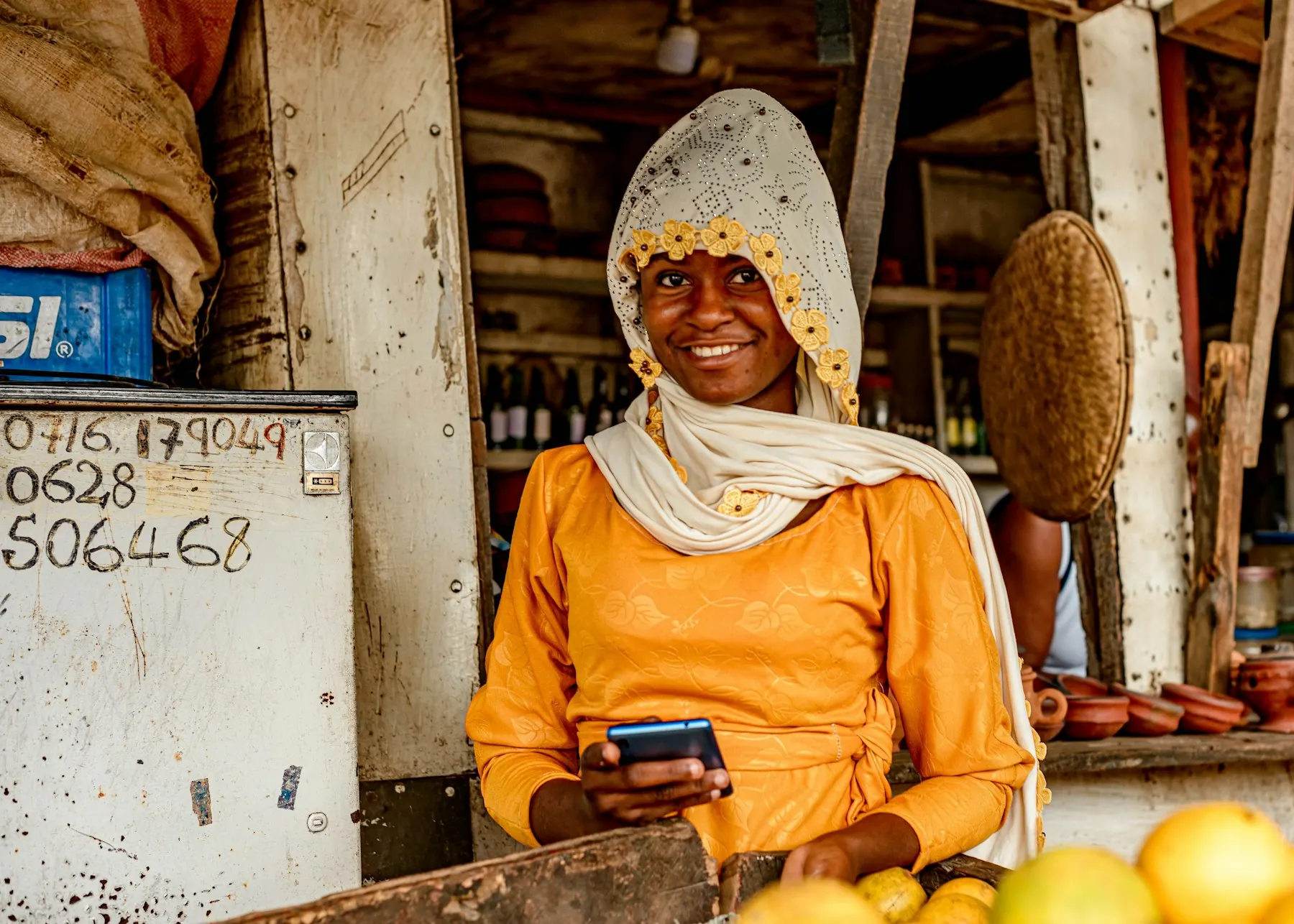 A market trader checking her phone