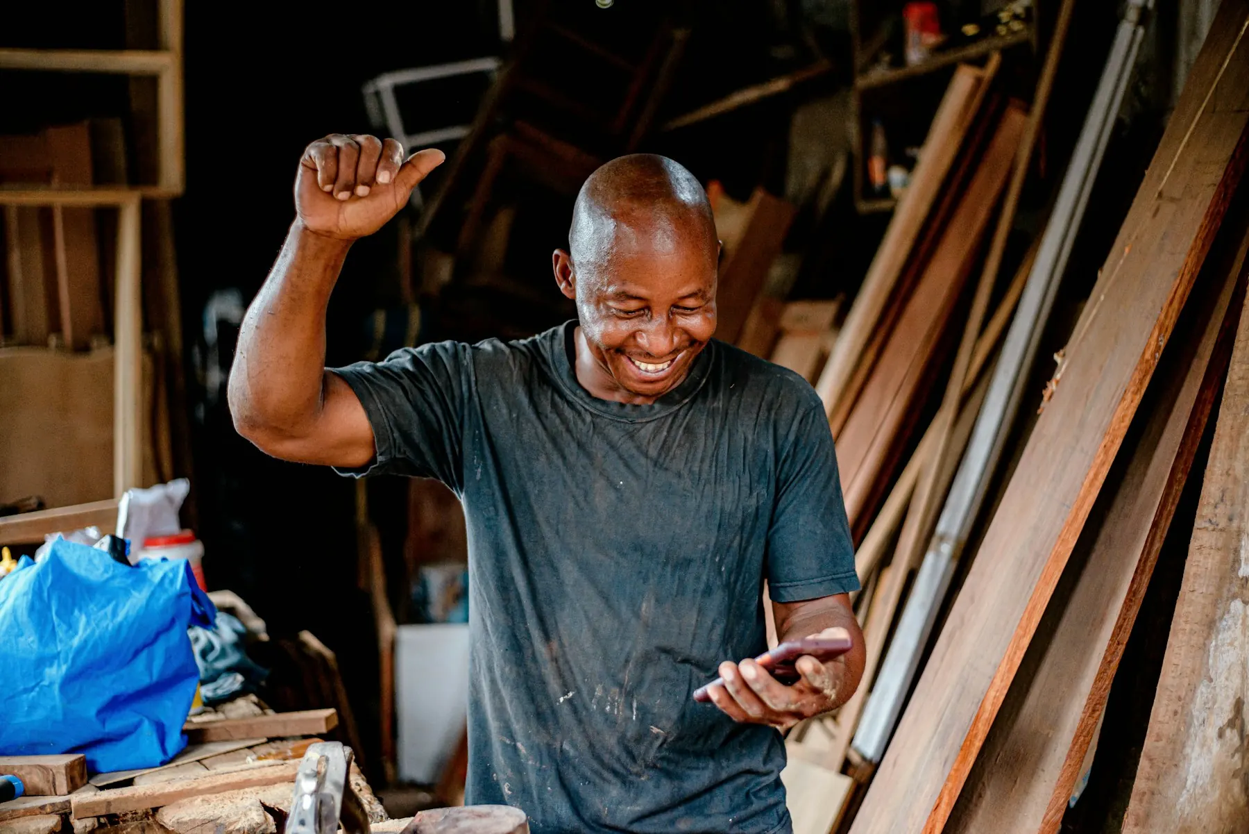 A man celebrating while reading his phone