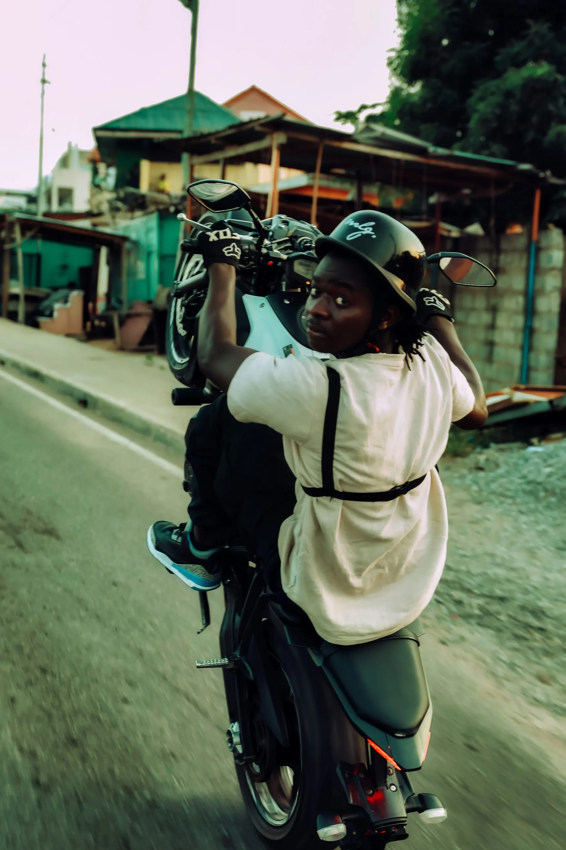 A rider on a motorbike on a town street
